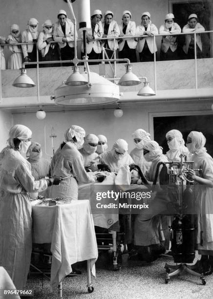 Female surgeon operating, watched by students, at the Royal Free Hospital, 23rd February 1938.