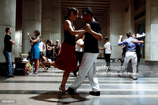 People dance Tango in Piazza Affari, head office of the Italian Stock Exchange, on July 29 2009 in Milan, Italy. The tango lovers are members of the...