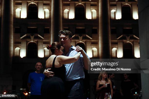 People dance Tango in Piazza Affari, head office of the Italian Stock Exchange, on July 29 2009 in Milan, Italy. The tango lovers are members of the...