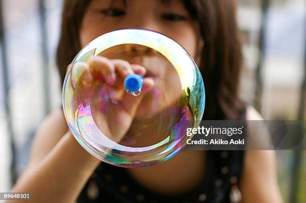 blowing soap bubble - blowing bubbles foto e immagini stock