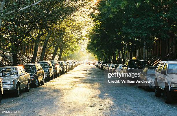 parked cars  on street - cars parked in a row stock pictures, royalty-free photos & images