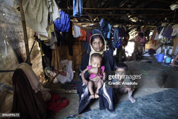 Years old Tahara poses with two children at a refugee camp in Cox's Bazar, Bangladesh on December 19, 2017. Tahara's husband was shot dead by...