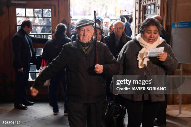 Man enters a polling station to cast his vote for the Catalan regional election in Barcelona on December 21, 2017. Catalans take their divisions over...