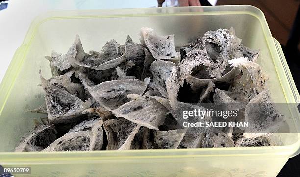 Malaysia-business-wildlife-birds,FEATURE by M. Jegathesan This photo taken on July 13, 2009 shows dried bird's nests preserved in a plastic box at a...