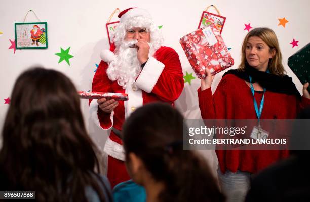 Inmates and children attend a Christmas gift giving event with a Santa Claus, organised at the Baumettes prison in Marseille, southern France, on...