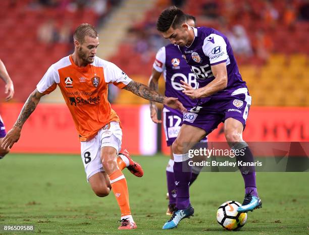 Brandon Wilson of the Glory looks to take on the defence of Jacob Pepper of the Roar during the round 11 A-League match between the Brisbane Roar and...