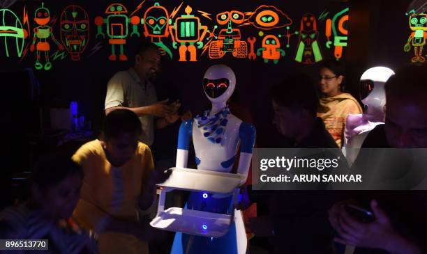 This photo taken on December 20, 2017 shows a robot waiter serving Indian customers at a robot-themed restaurant in Chennai. India's first...