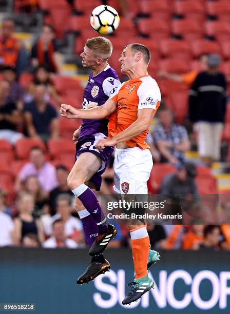Andrew Keogh of the Glory and Luke DeVere of the Roar compete for the ball during the round 11 A-League match between the Brisbane Roar and the Perth...
