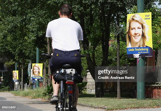Cyclist pasts a campaign placard of Linda Teuteberg, of the German Free Democrats , on August 7, 2009 in Potsdam, Germany. Teuteberg candidates for...