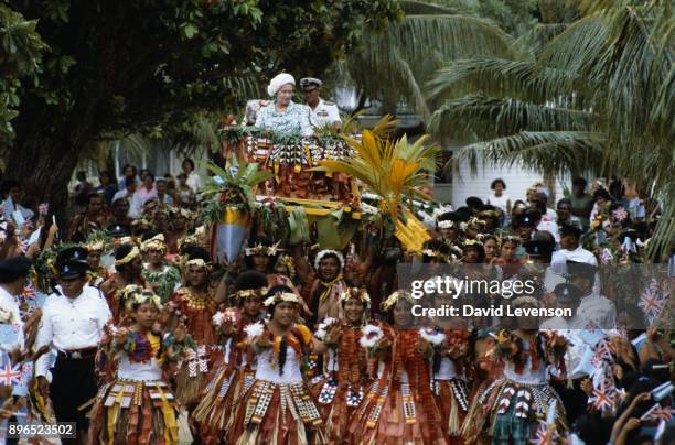 Queen Elizabeth II and Prince Philip are carried on local canoes to the Vaiaku maneapa of Funfuti in Tuvalu on October 26, 1982 during the Royal Tour...