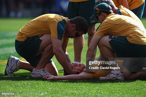 Berrick Barnes, the Wallaby centre, receives attention after being injured during the Wallabies captain's run at Newlands Stadium on August 7, 2009...