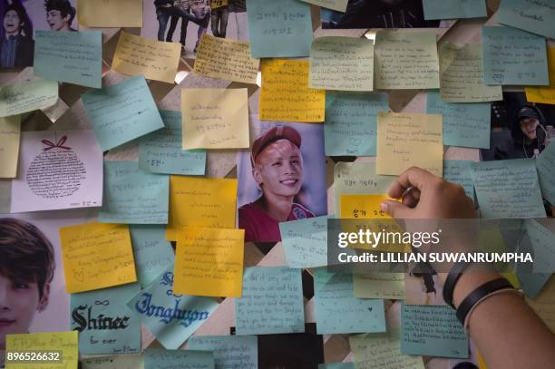 Thai fan of the late South Korean band SHINee singer Kim Jong-Hyun puts up a note for him during a memorial held by the boyband's Thai fanclub at a...