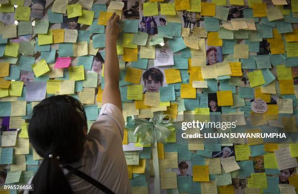 Thai fan of the late South Korean band SHINee singer Kim Jong-Hyun puts up a note for him during a memorial held by the boyband's Thai fanclub at a...