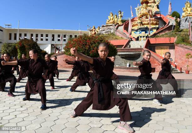 Nepali Buddhist nuns practise kung fu at the Amitabha Drukpa Nunnery on the outskirts of Kathmandu on December 21, 2017. / AFP PHOTO / PRAKASH MATHEMA