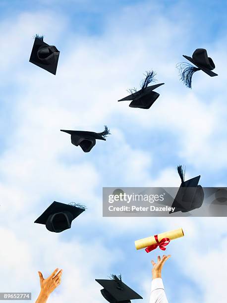 university mortarboards and certificates. - graduation excitement stock pictures, royalty-free photos & images