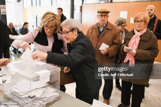 People cast their vote inside a polling station at the University School of Industrial Technical Engineering of Barcelona on December 21, 2017 in...