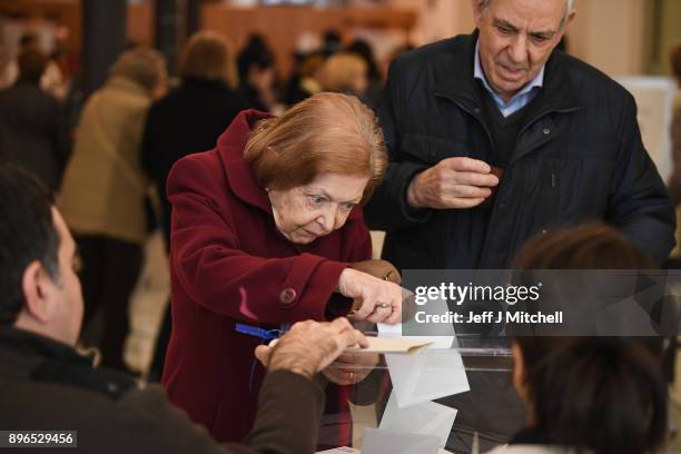 People cast their vote inside a polling station at the University School of Industrial Technical Engineering of Barcelona on December 21, 2017 in...