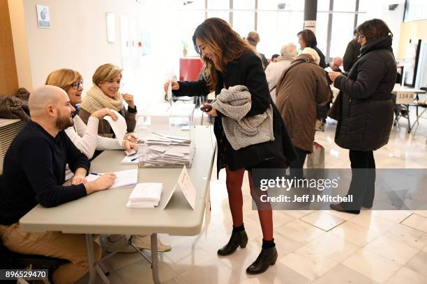 People cast their vote inside a polling station at the University School of Industrial Technical Engineering of Barcelona on December 21, 2017 in...