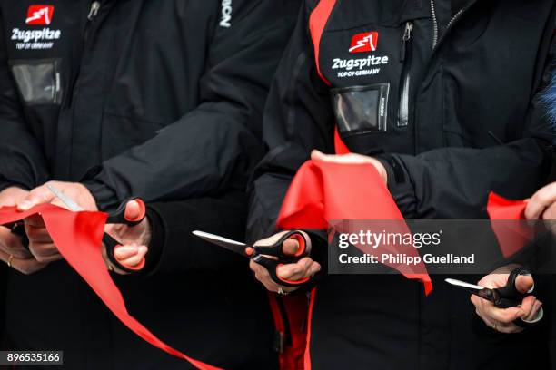 Officials cut a ribbon during the inauguration of the new "Eibsee Seilbahn" cable car connection on December 21, 2017 in Grainau, Germany. The...