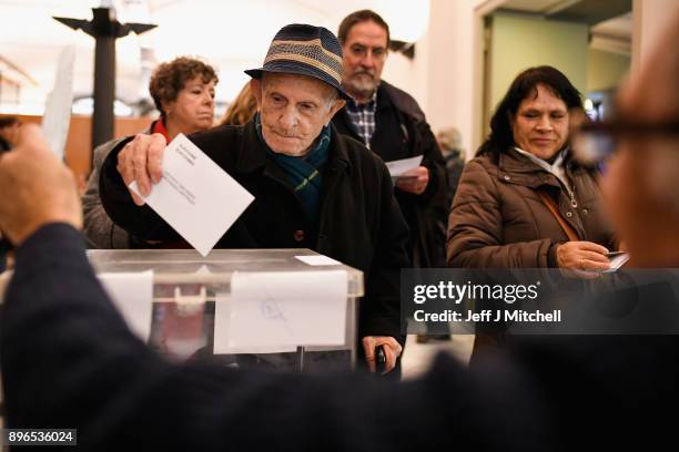 People cast their vote inside a polling station at the University School of Industrial Technical Engineering of Barcelona on December 21, 2017 in...