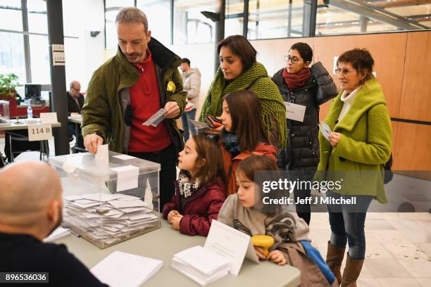 People cast their vote inside a polling station at the University School of Industrial Technical Engineering of Barcelona on December 21, 2017 in...