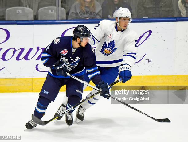 Michael Paliotta of the Toronto Marlies battles with Michael Sgarbossa of the Manitoba Moose during AHL game action on December 17, 2017 at Ricoh...
