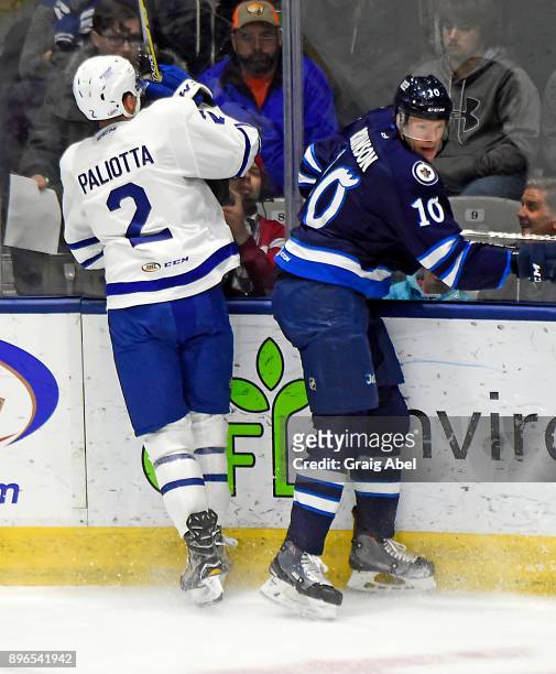 Michael Paliotta of the Toronto Marlies gets hit by Buddy Robinson of the Manitoba Moose during AHL game action on December 17, 2017 at Ricoh...