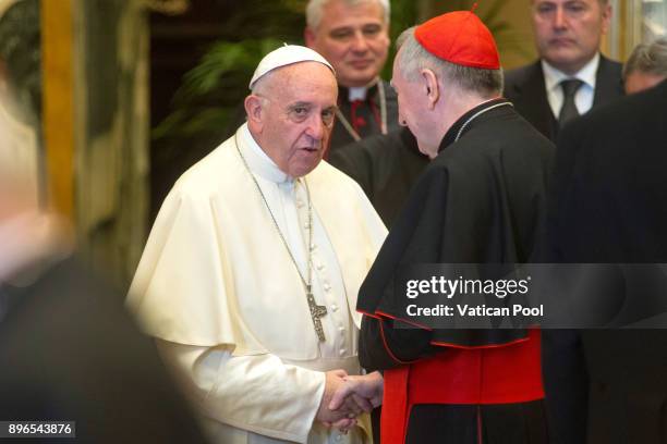 Pope Francis exchanges Christmas greetings with Vatican Secretary of State cardinal Pietro Parolin at the Clementina Hall on December 21, 2017 in...