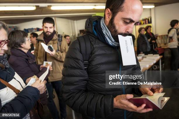 Voters wait to cast their ballot for the Catalan regional election at Fort Pienc school polling station on December 21, 2017 in Barcelona, Spain....