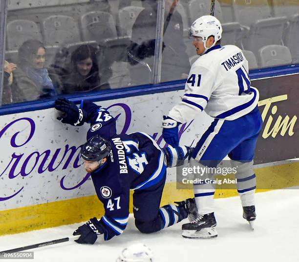 Dmytro Timashov of the Toronto Marlies puts a hit on Charles-David Beaudoin of the Manitoba Moose during AHL game action on December 17, 2017 at...