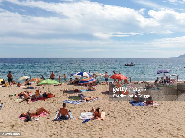 people swimming and relaxing on the beach along the mediterranean coast of france - cannes beach stock pictures, royalty-free photos & images