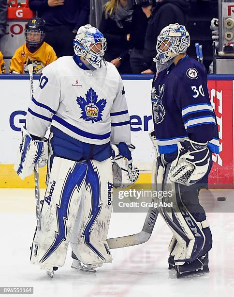 Jamie Phillips of the Manitoba Moose and Garret Sparks of the Toronto Marlies have a chat in warmup prior to a game on December 17, 2017 at Ricoh...