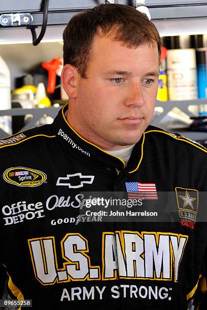 Ryan Newman, driver of the U.S. Army Chevrolet, stands in the garage during practice for the NASCAR Sprint Cup Series Heluva Good! Sour Cream Dips at...