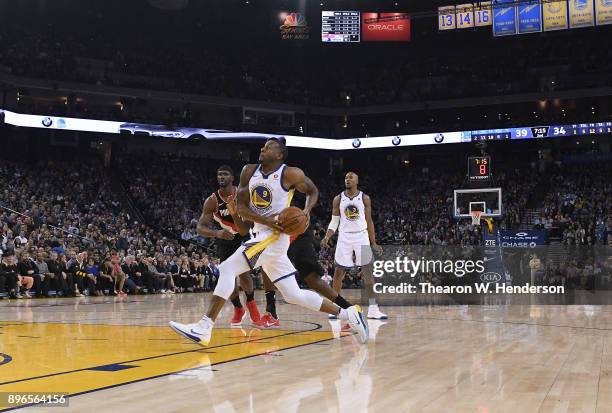 Andre Iguodala of the Golden State Warriors drives to the basket on Al-Farouq Aminu of the Portland Trail Blazers during an NBA basketball game at...