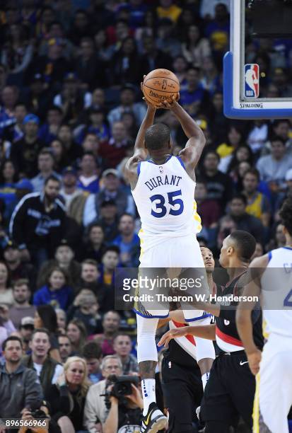 Kevin Durant of the Golden State Warriors shoots against the Portland Trail Blazers during an NBA basketball game at ORACLE Arena on December 11,...