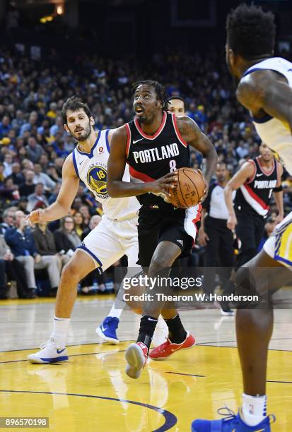 Al-Farouq Aminu of the Portland Trail Blazers drives towards the basket against the Golden State Warriors during an NBA basketball game at ORACLE...