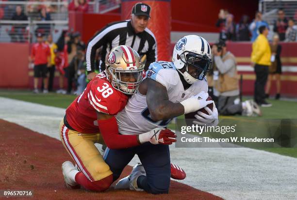 Delanie Walker of the Tennessee Titans catches a touchdown pass over Adrian Colbert of the San Francisco 49ers during their NFL football game at...