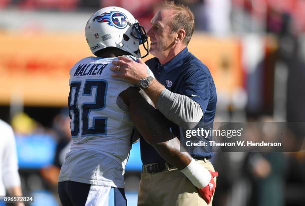 Head coach Mike Mularkey of the Tennessee Titans embraces his player Delanie Walker during pregame warm ups prior to the start of an NFL football...