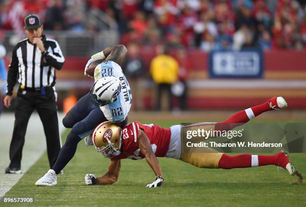 Delanie Walker of the Tennessee Titans gets tackled by Ahkello Witherspoon of the San Francisco 49ers during their NFL football game at Levi's...