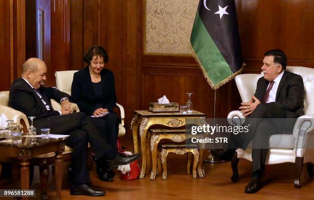 Government of National Accord prime minister Fayez al-Sarraj meets with French Foreign Minister Jean-Yves Le Drian in the Libyan capital Tripoli on...