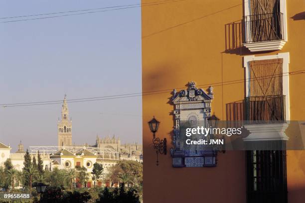 Triana quarter, Seville Ceramic decoration of a house with an image of the Virgin, behind the Royal Maestranza Bullring and the Giralda Tower