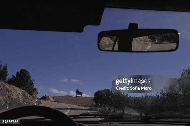 Advertising barrier of the bull of Osborne View of an advertising barrier of the bull of Osborne from a car on the highway of Medinaceli, Soria...