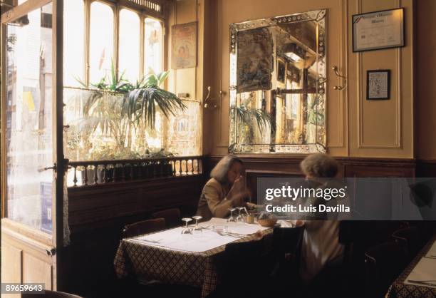 People eat in the Polidor restaurant Two women eat in the living room of the literary restaurant of Polidor of Paris