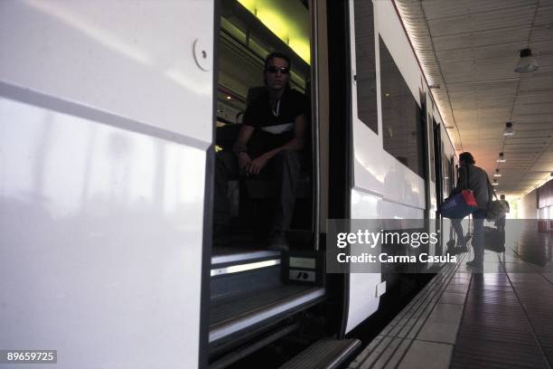 Passengers ascending to a train A passenger goes up to a train of proximities in a station