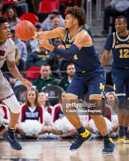 Isaiah Livers of the Michigan Wolverines passes the ball against the Detroit Titans during game one of the Hitachi College Basketball Showcase at...