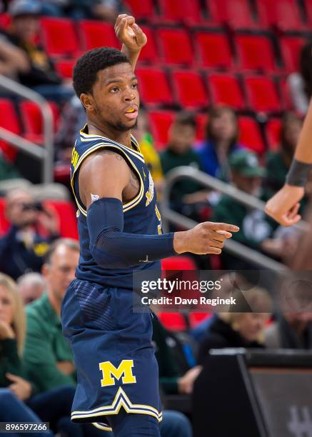 Zavier Simpson of the Michigan Wolverines follows the play against the Detroit Titans during game one of the Hitachi College Basketball Showcase at...