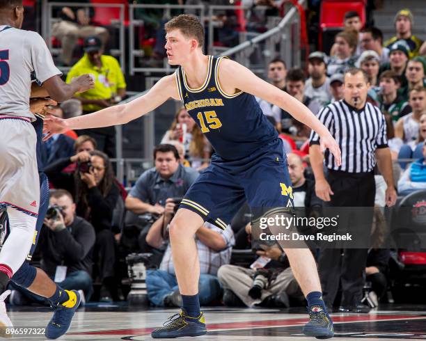 Jon Teske of the Michigan Wolverines defends against Detroit Titans during game one of the Hitachi College Basketball Showcase at Little Caesars...