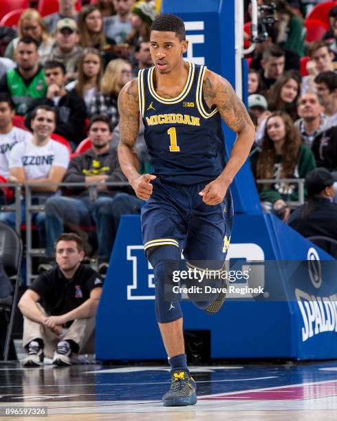 Charles Matthews of the Michigan Wolverines runs up court against the Detroit Titans during game one of the Hitachi College Basketball Showcase at...