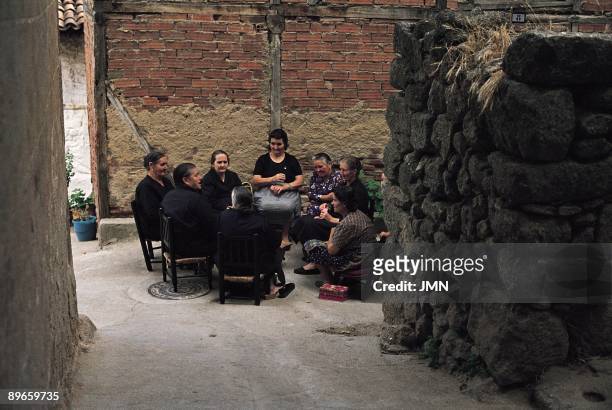 Old women coterie. Aldeanueva de la Vera. Caceres A group of old women, most dressed of mourning, speak in the street in the typical wooden seats and...