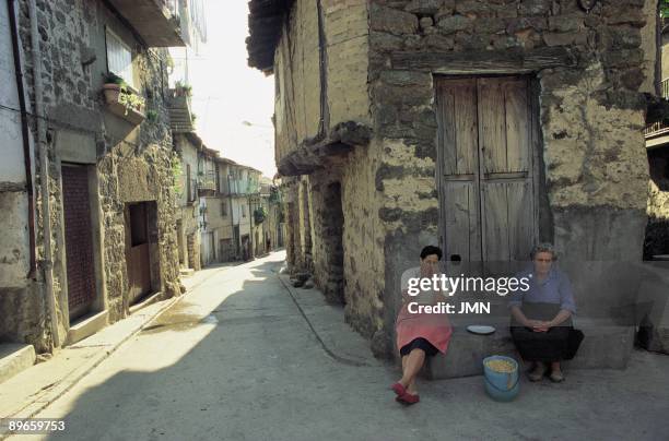 Women of Hoyos. Caceres Two women of the town sat down in front the facade of a house that conserves their popular architecture